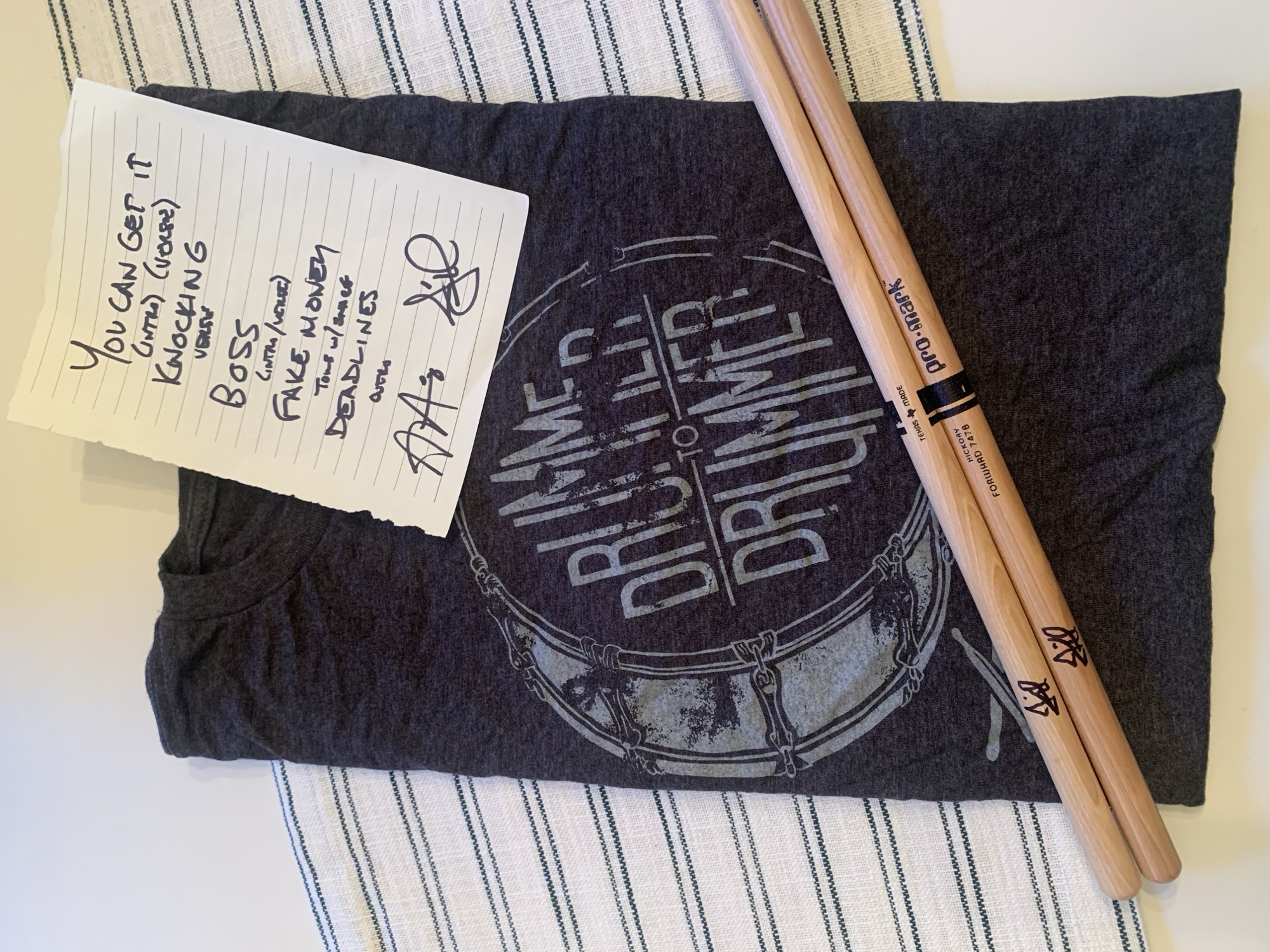 A contest prize - signed drumsticks, a handwritten setlist, and a Drummer to Drummer shirt