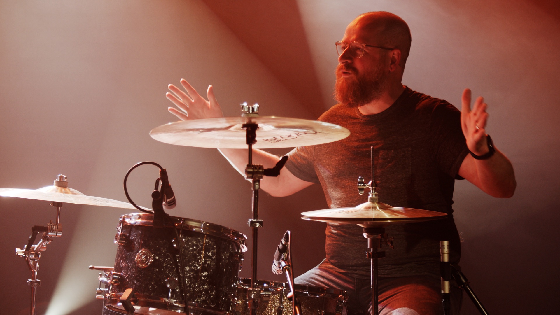 A graded frame from the finished cut - a drummer at the kit in warm light