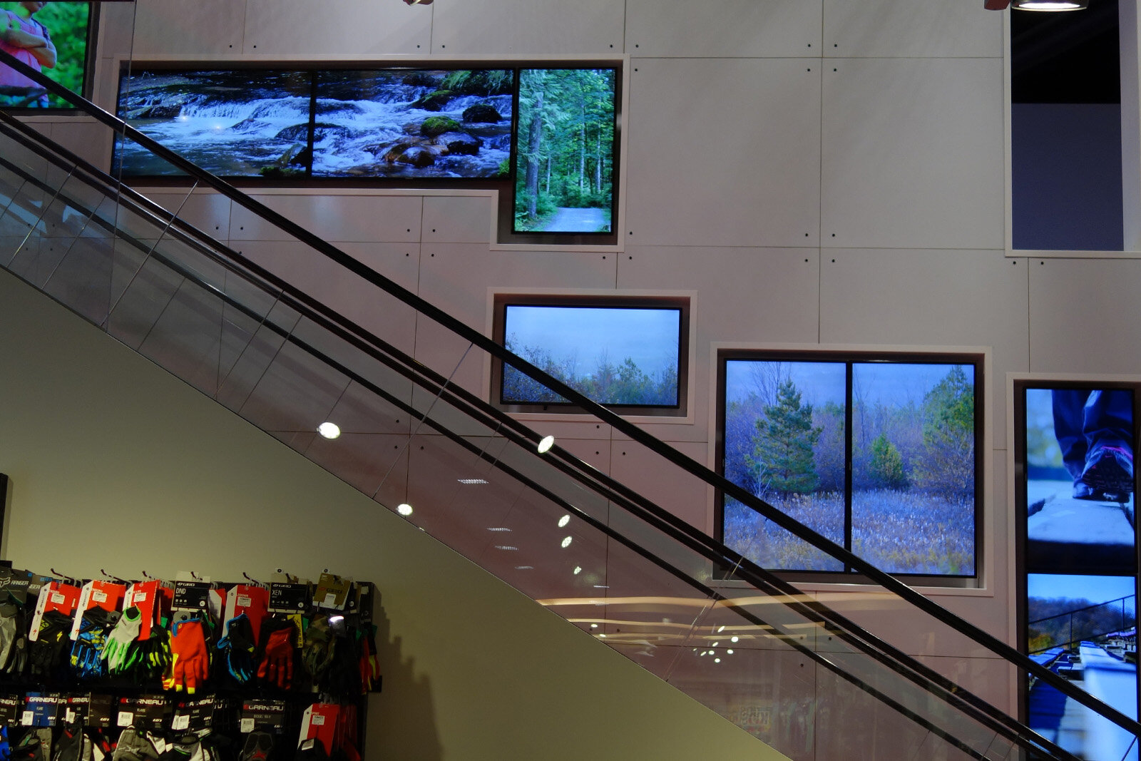 The escalator mosaic at West Edmonton Mall - screens of several sizes staggered up the wall alongside the escalator, running the ambient nature state